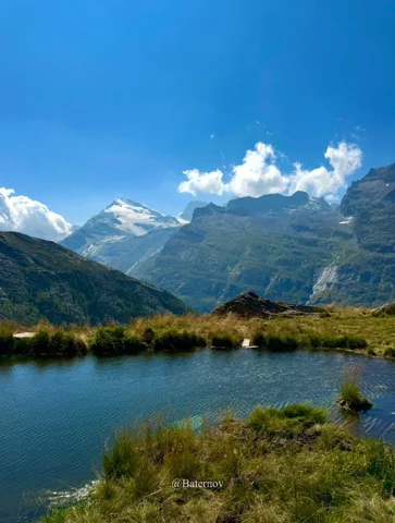 Small mountain lake reflecting the blue sky