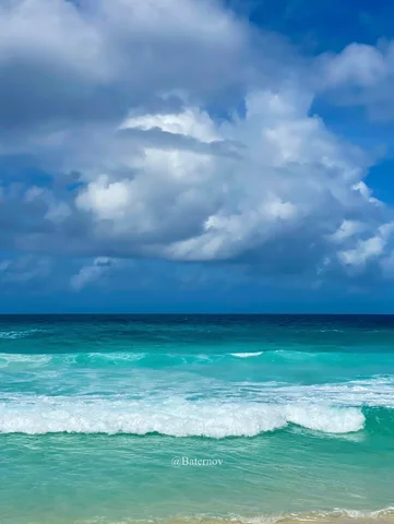 Breaking waves beneath heavy clouds