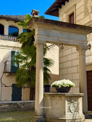 Stone columns and a well in a sunny courtyard
