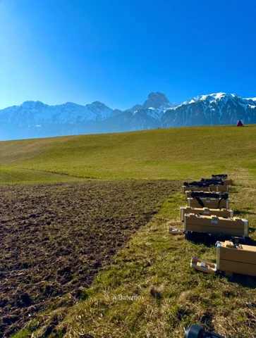 Equipment arranged beside a field with mountains beyond