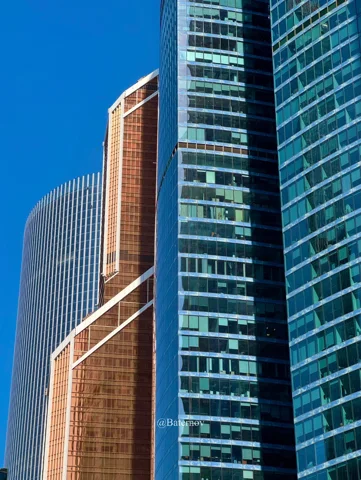 Glass skyscrapers against a clear blue sky