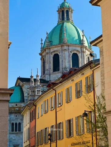 Green domed tower above warm-coloured buildings