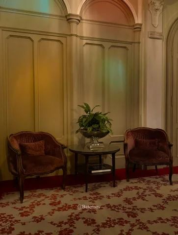 Two armchairs in an ornate sitting room