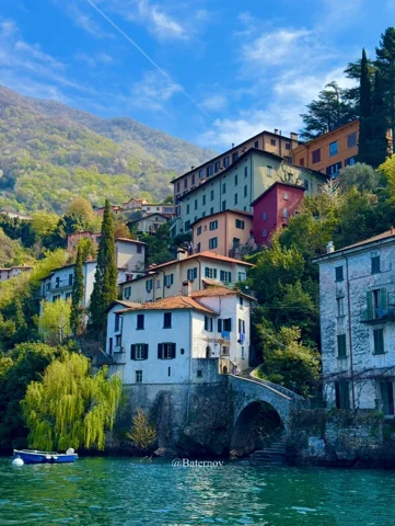 Waterfront houses rising above a stone arch