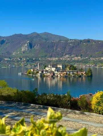 Small island with buildings in a mountain lake
