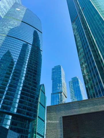 Upward view between modern glass towers