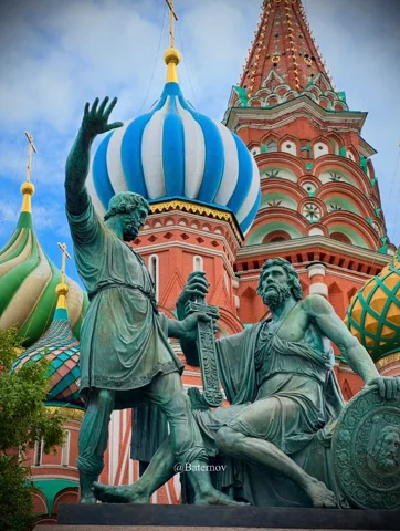 Bronze monument before brightly coloured onion domes