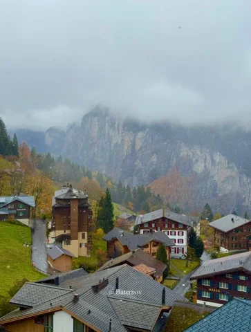 Village rooftops beneath a low bank of cloud