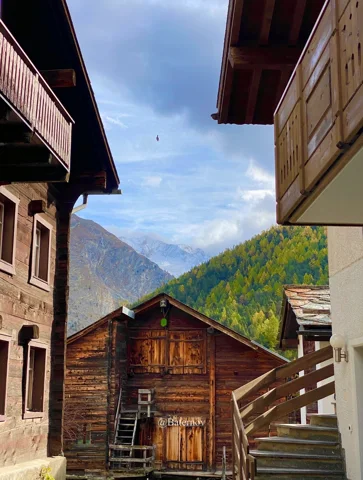 Wooden houses framing a mountain view