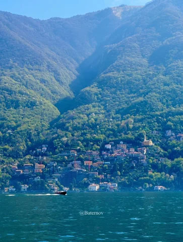 Hillside village across a blue lake
