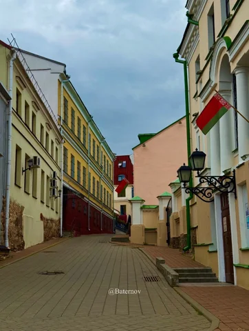 Quiet pedestrian street lined with pastel buildings