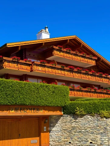 Wooden chalet with flower-filled balconies