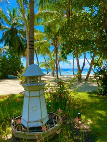 Decorative lantern in a palm garden beside the beach