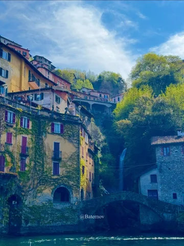 Old stone buildings beside a shaded ravine