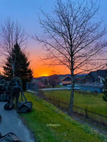 Soldier near a tree at sunset