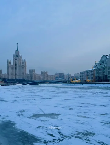 Frozen river facing a tall city building