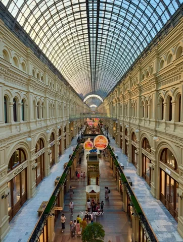 Long shopping arcade beneath a vaulted glass roof