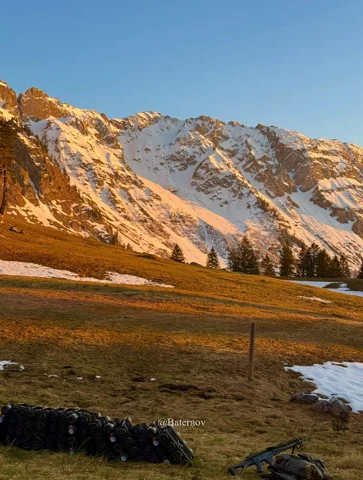 Snow-streaked mountains lit by the evening sun