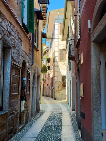 Narrow paved lane between colourful facades