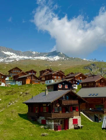 Scattered wooden chalets on a mountain pasture