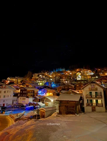 Village lights scattered across a hillside at night