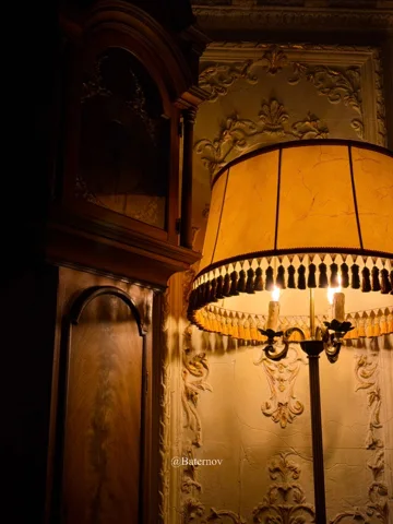 Warm lampshade beside decorative interior walls