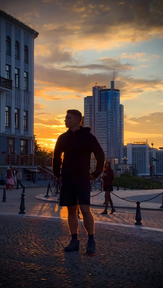 Brandon standing on a cobbled street at sunset.